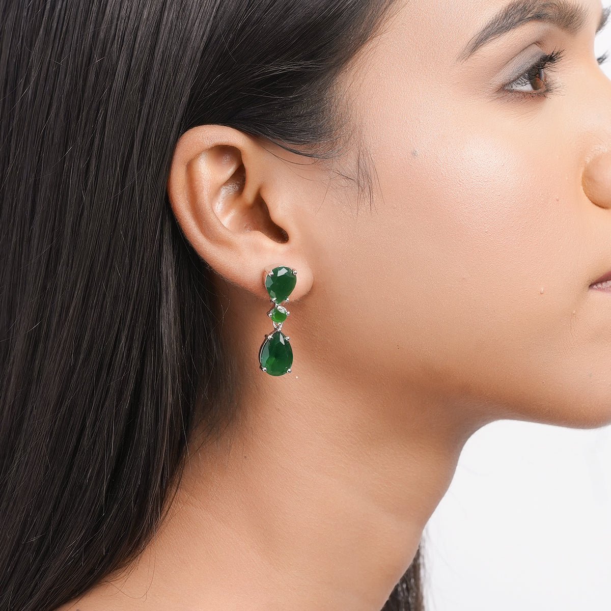 Side profile showing depth and clasp of green drop earrings