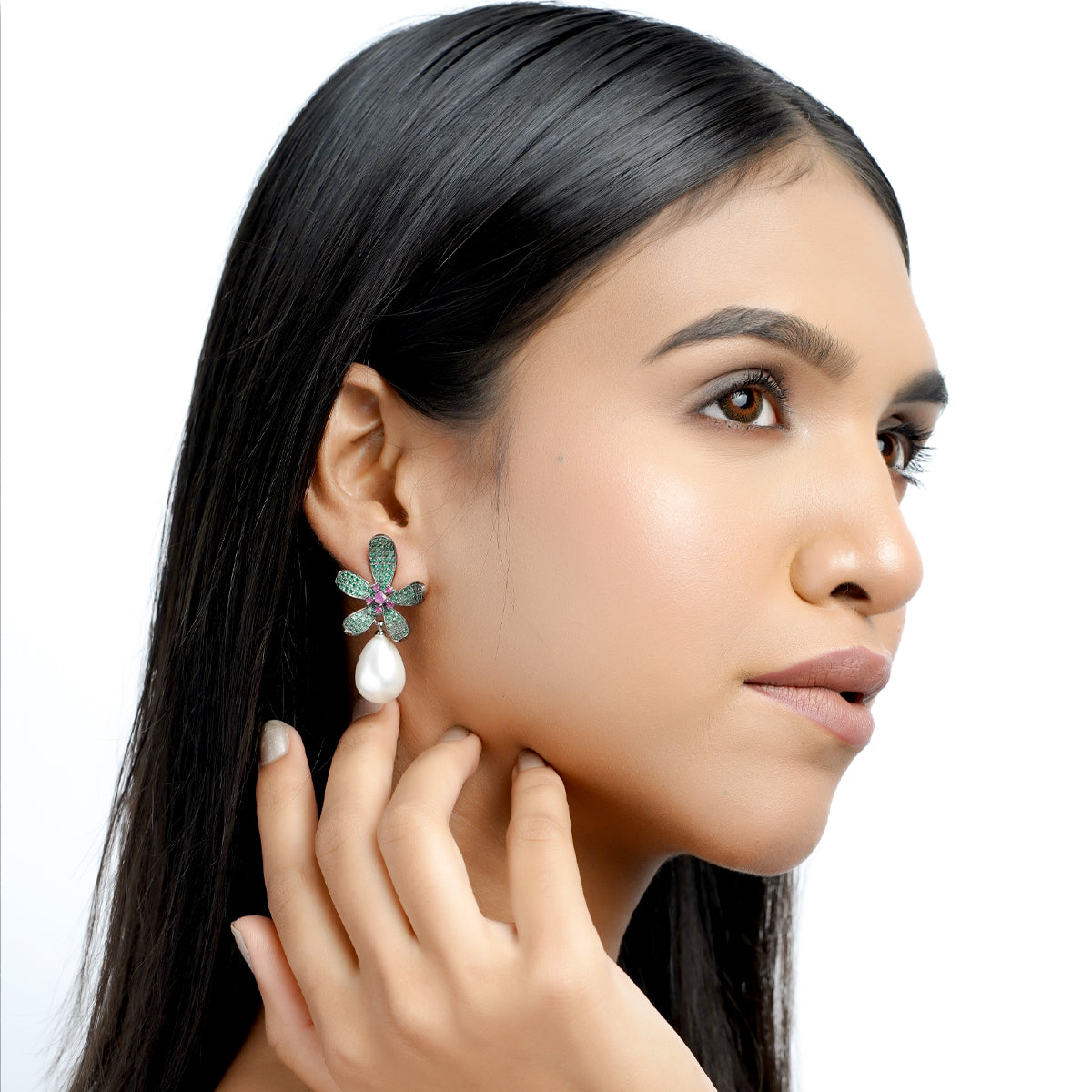 Angled side model view of green flower and pearl earrings