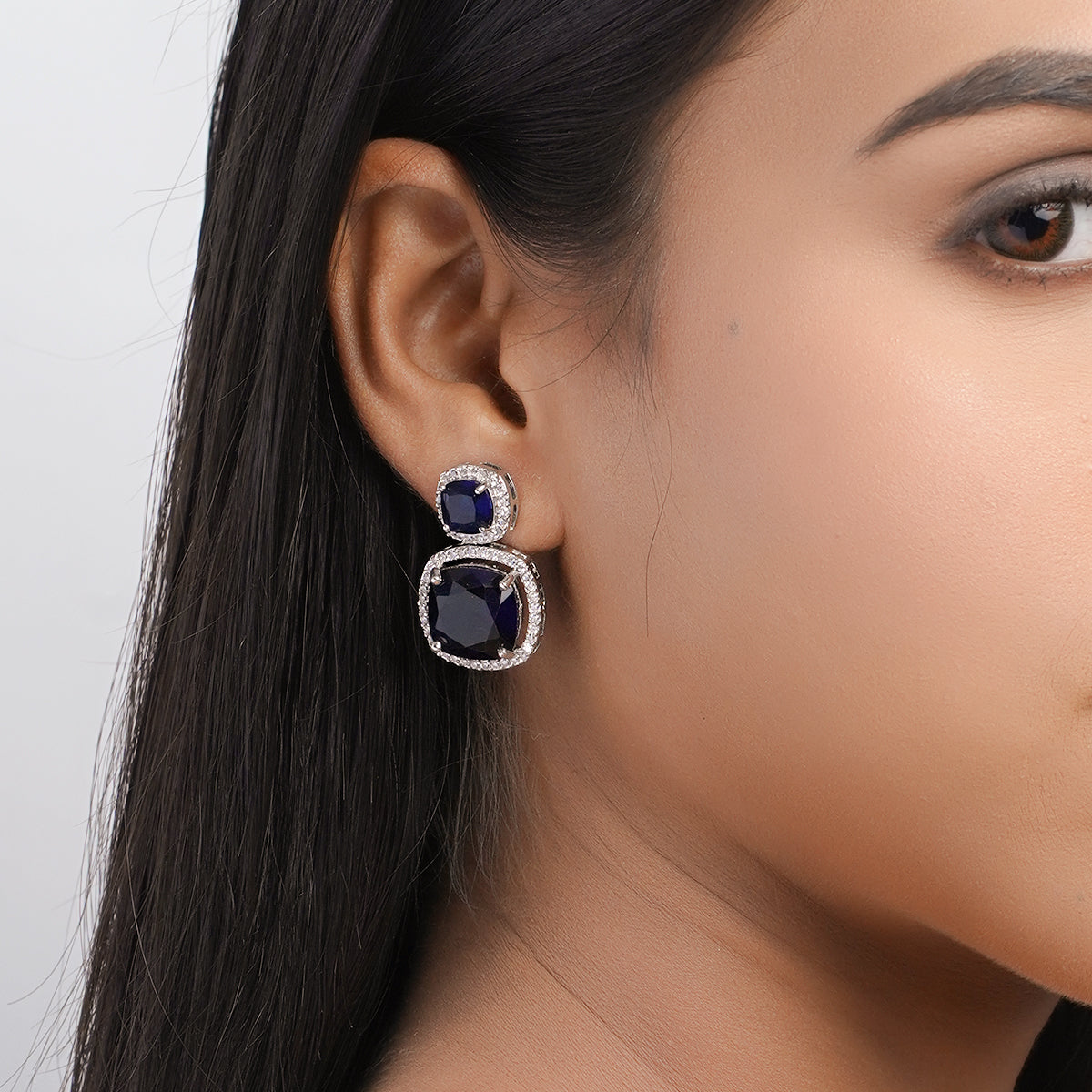 Model wearing blue stone drop earring – side close-up view”