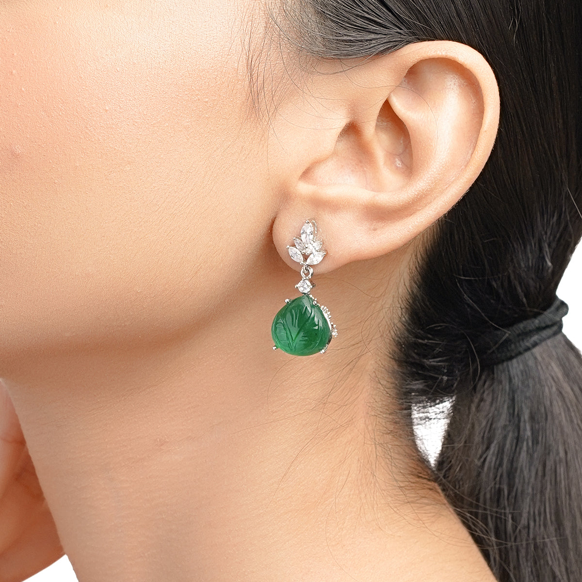 Model showing green CZ earring from ear close-up