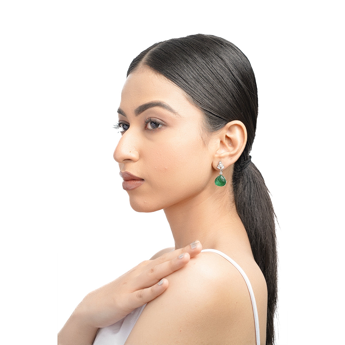 Model front pose showing full look with green CZ earrings