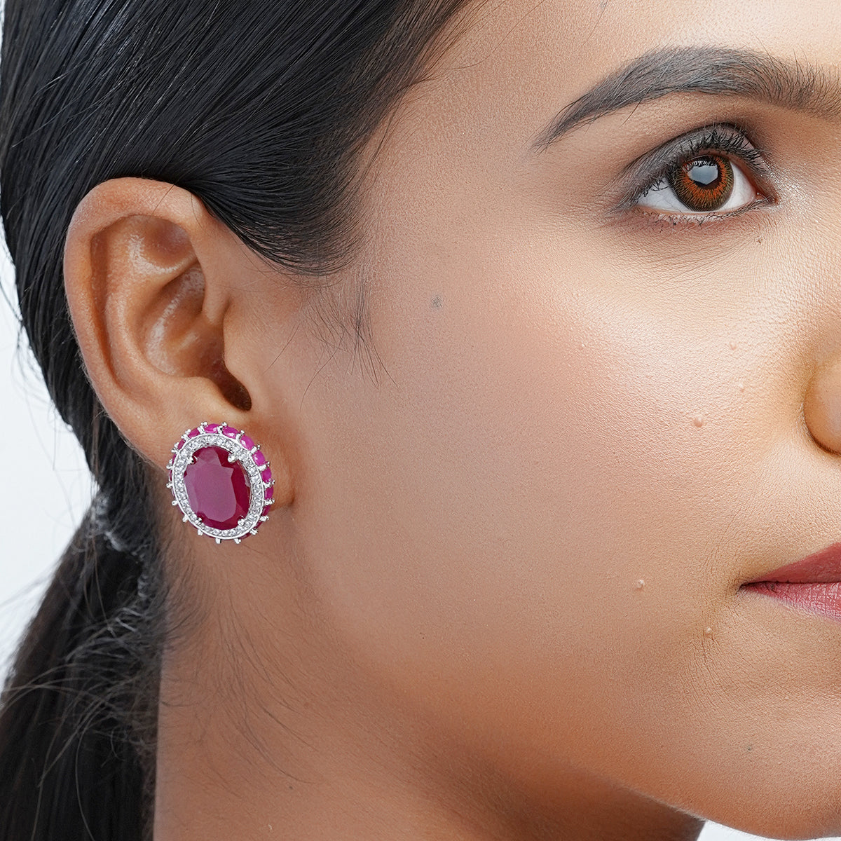 Model showing full side profile wearing ruby CZ earrings