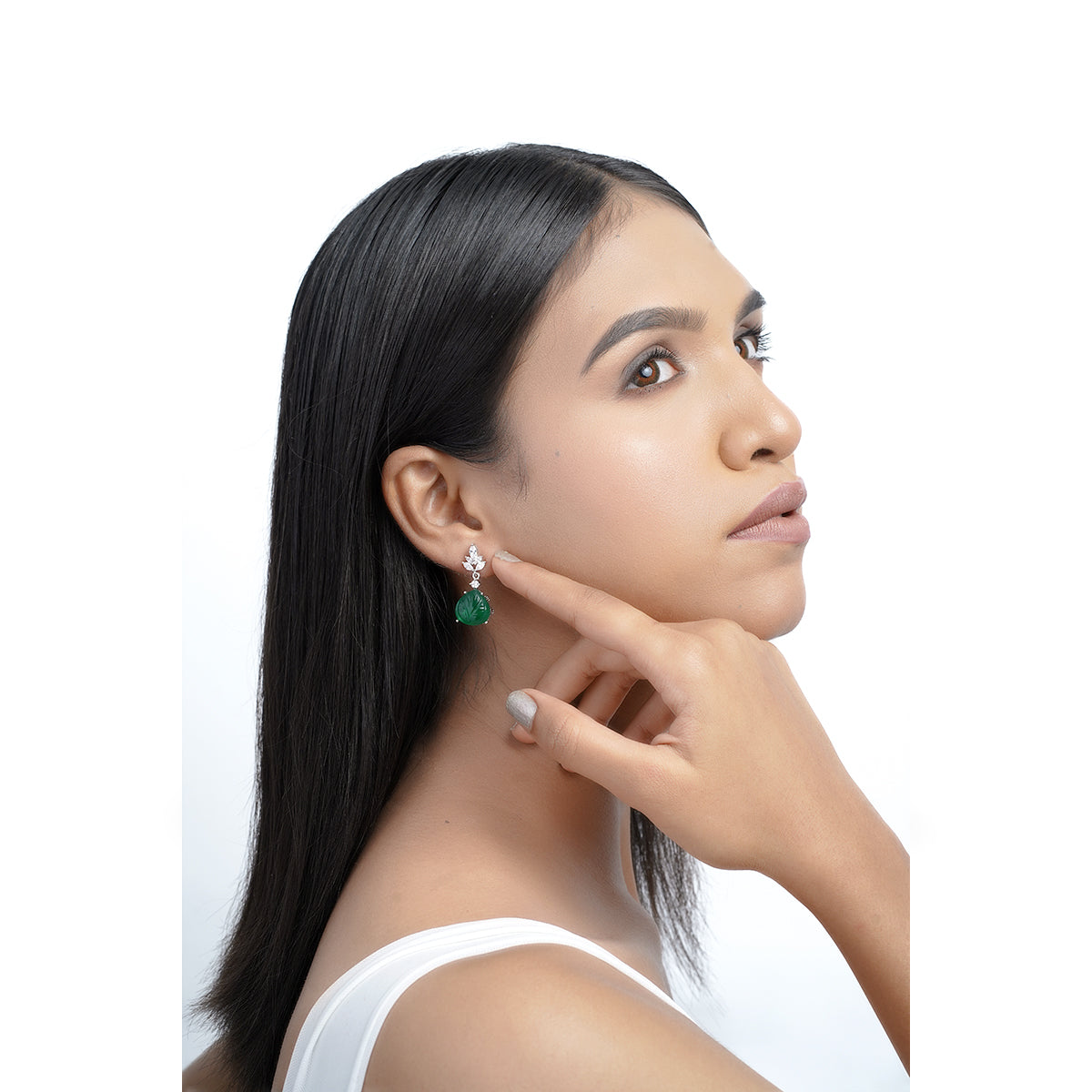 Side view of model wearing green CZ drop earrings
