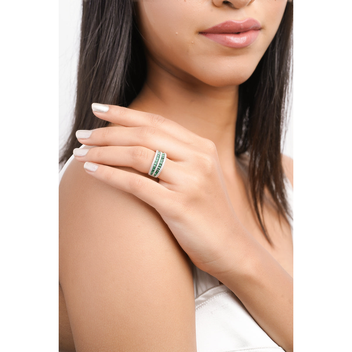 Model wearing bold green triple row CZ ring with clean look