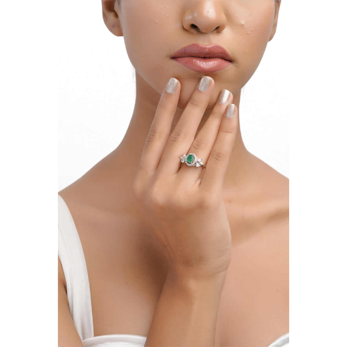 Model wearing green stone ring, showing hand and upper body