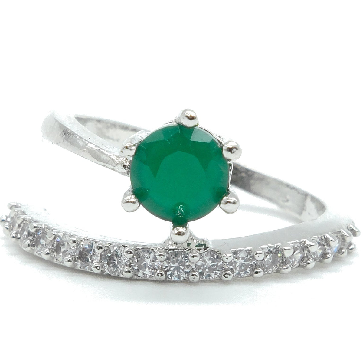 A silver ring featuring a round green emerald-cut center stone and a curved pavé band set with small clear stones, shown on a white background.
