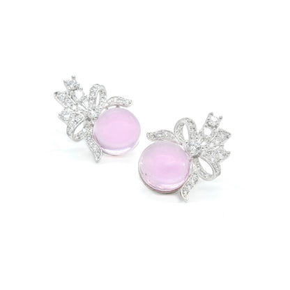 Front view of baby pink stud earrings with bow design and white stones