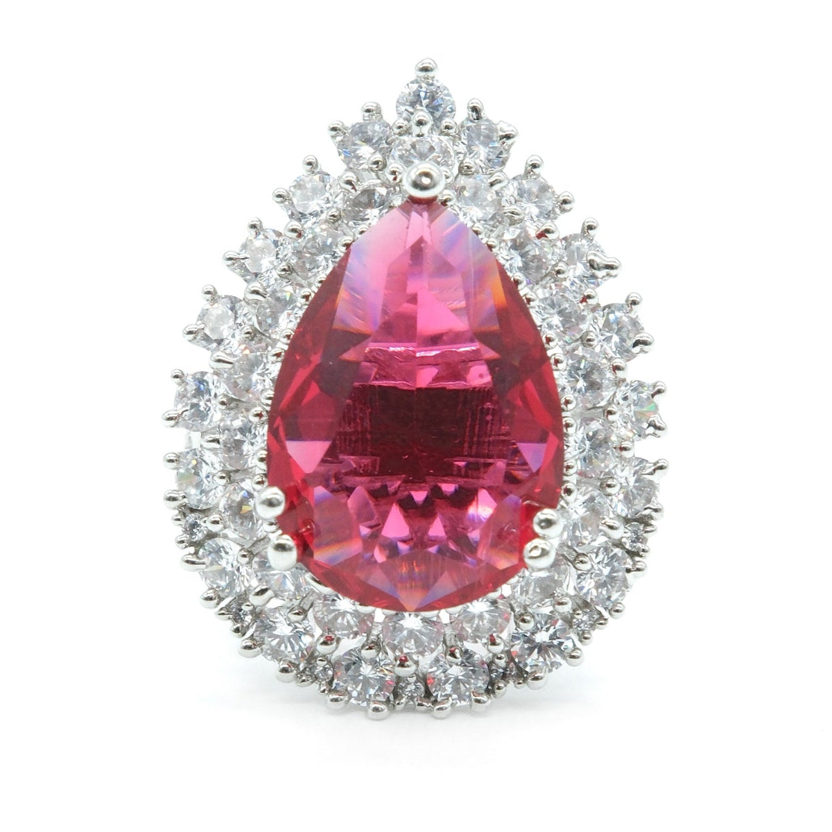 A teardrop-shaped halo ring featuring a large faceted pink gemstone in the center, surrounded by a double halo of small clear stones in a silver-toned setting, isolated on a white background.