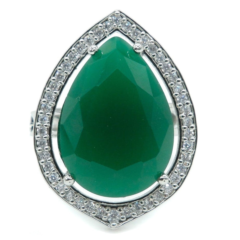 A teardrop-shaped green gemstone ring with a silver pavé halo, set against a plain white background.