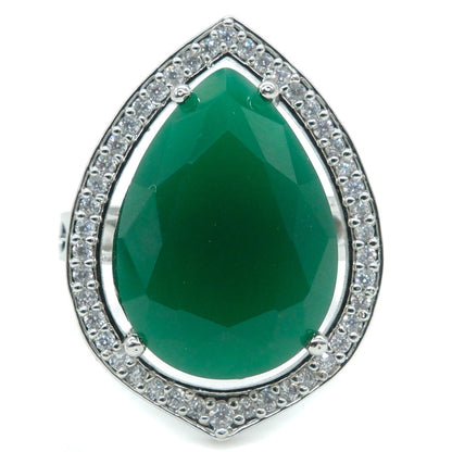 A teardrop-shaped green gemstone ring with a silver-toned halo setting accented by small clear stones, shown on a plain white background.