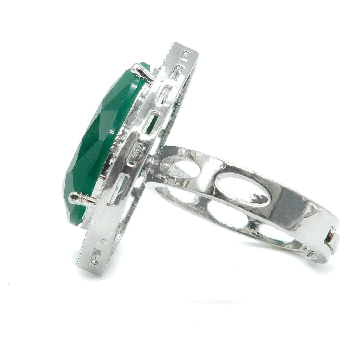 A silver ring featuring a large oval-cut green gemstone in a decorative bezel setting, shown on a plain white background.
