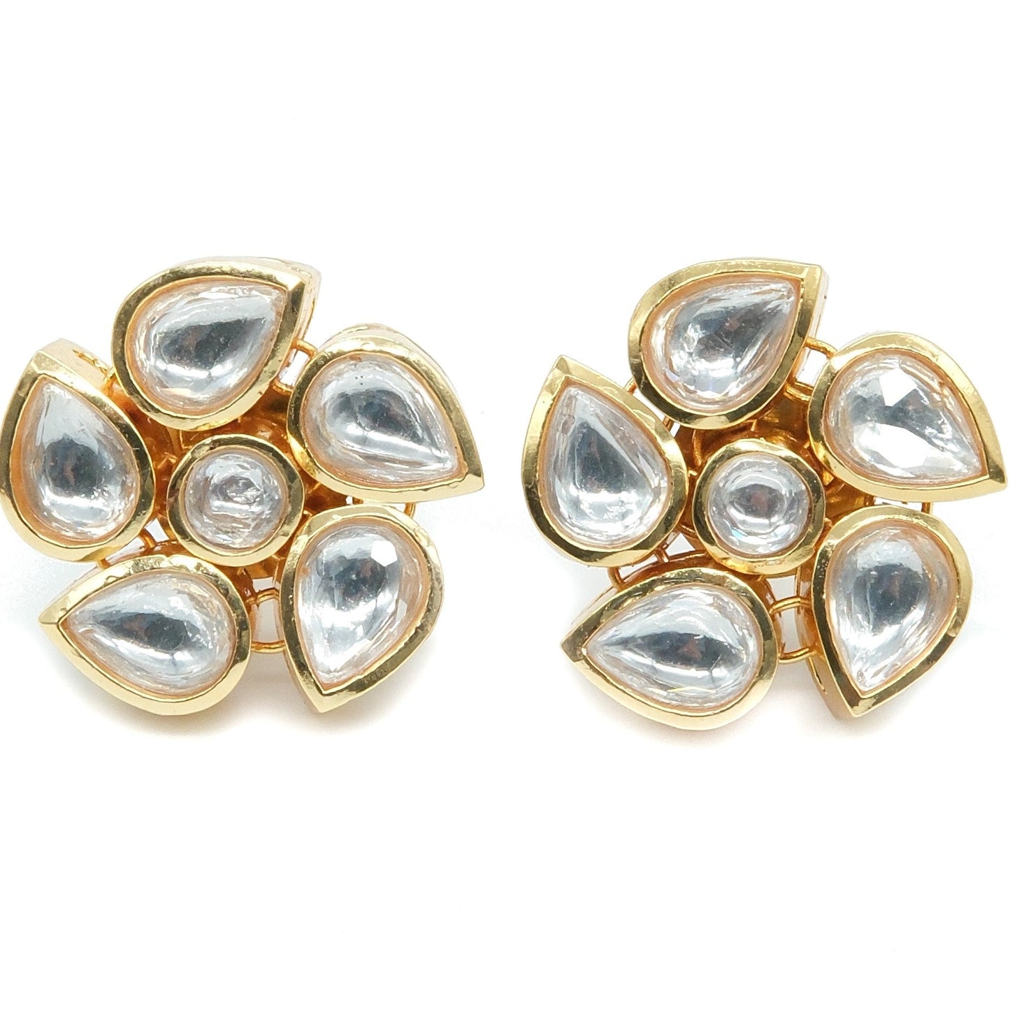 A pair of gold-plated stud earrings featuring seven clear teardrop-shaped and round stones arranged in a floral cluster, set against a plain white background.