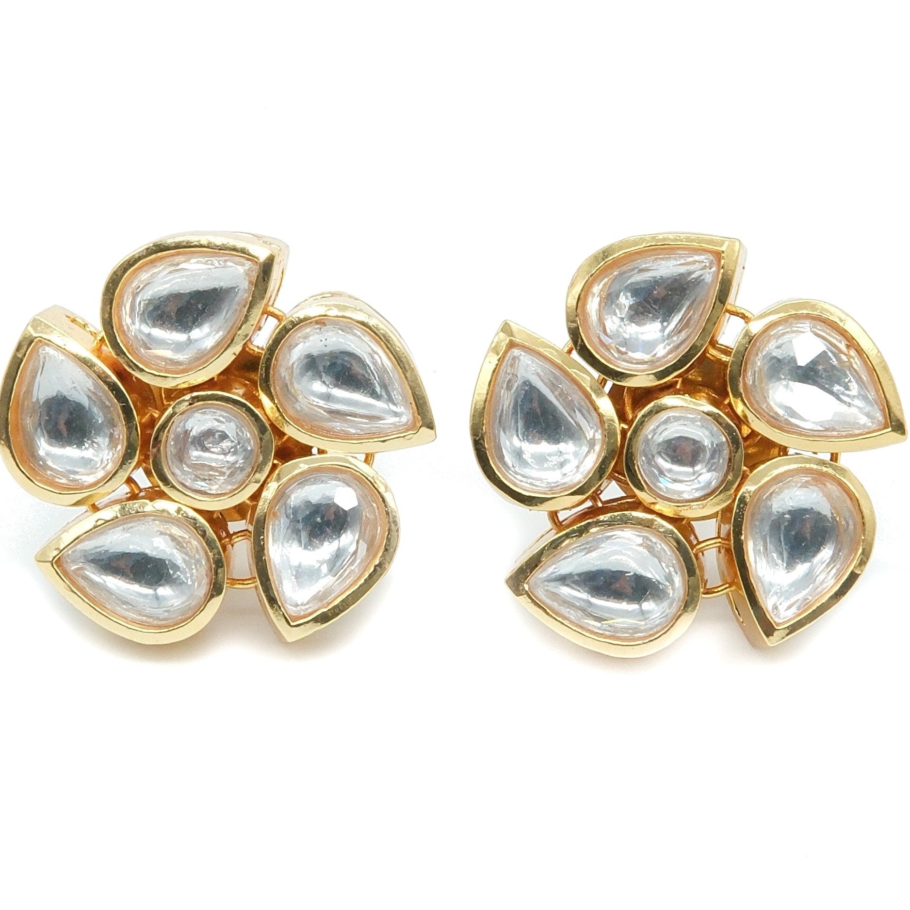 A pair of gold-plated stud earrings featuring seven clear teardrop-shaped and round stones arranged in a floral cluster, set against a plain white background.
