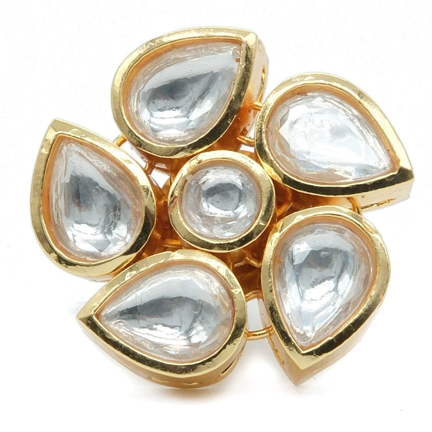 A gold-tone cluster ring featuring seven teardrop-shaped clear stones set in a floral arrangement on a white background.