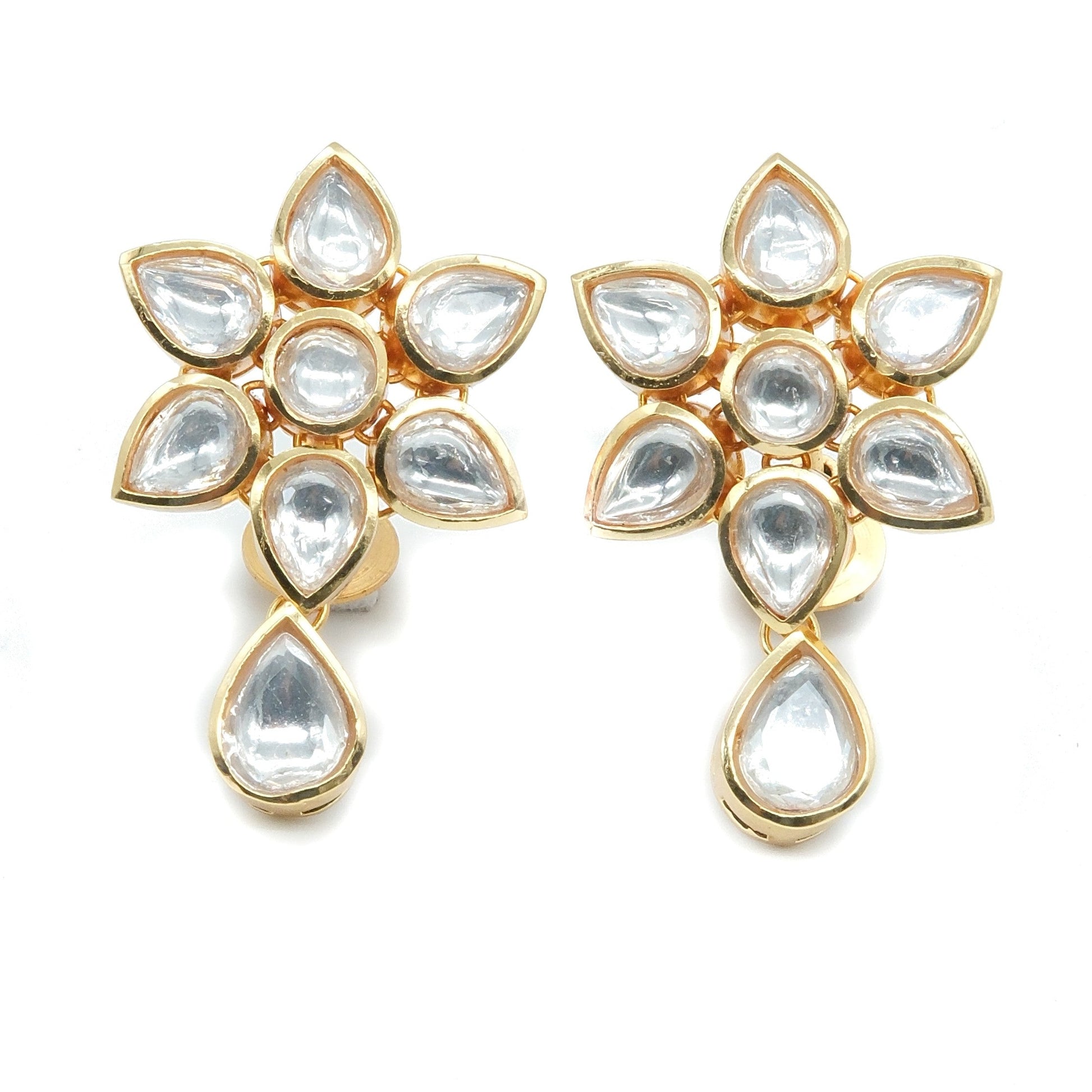 A pair of gold-plated floral earrings featuring clear teardrop-shaped and round stones, arranged symmetrically on a plain white background.