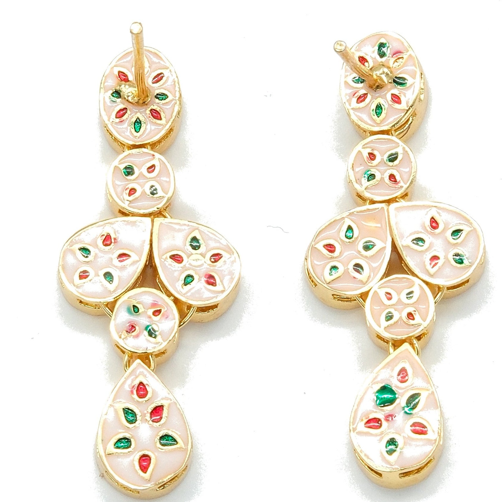 A pair of gold-plated dangle earrings with white enamel inlay and small red and green floral accents, displayed on a clean white background.