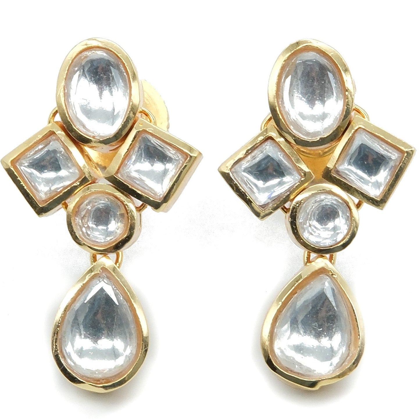 A pair of gold-plated drop earrings featuring clear, faceted stones in a traditional Indian Kundan style, set against a plain white background.