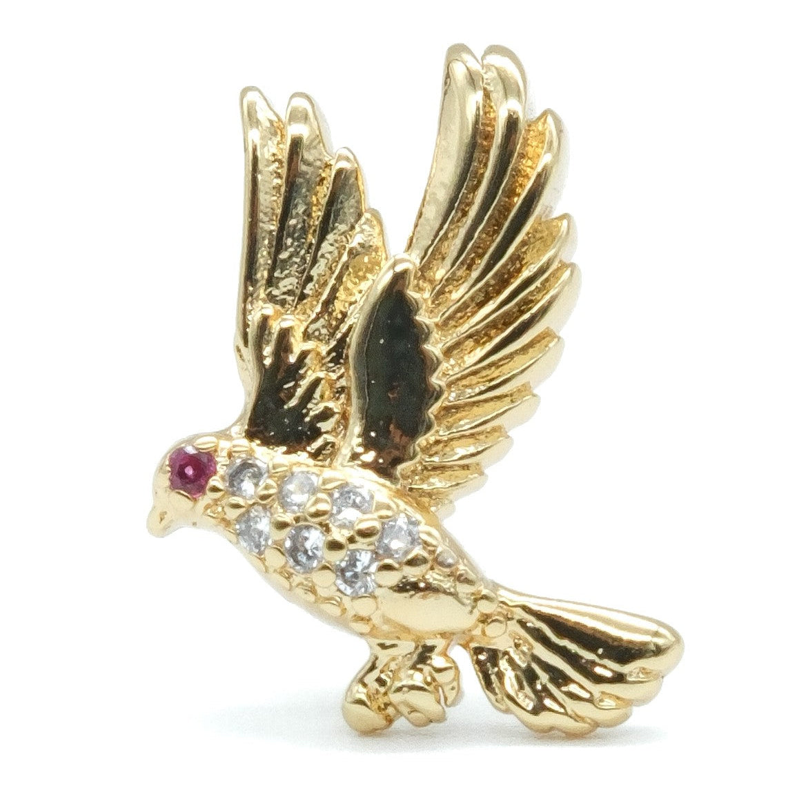 A gold bird brooch with wings spread, featuring a small red gemstone for the eye and clear rhinestones across the body, shown on a plain white background.