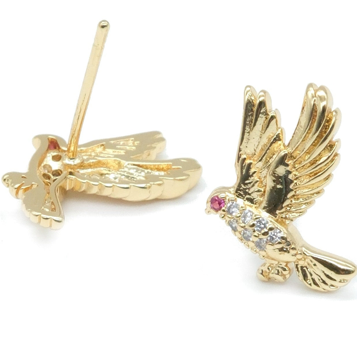 A pair of gold bird stud earrings on a white background, with one earring showing the back and the other showing the front decorated with a small pink gemstone and clear stones.