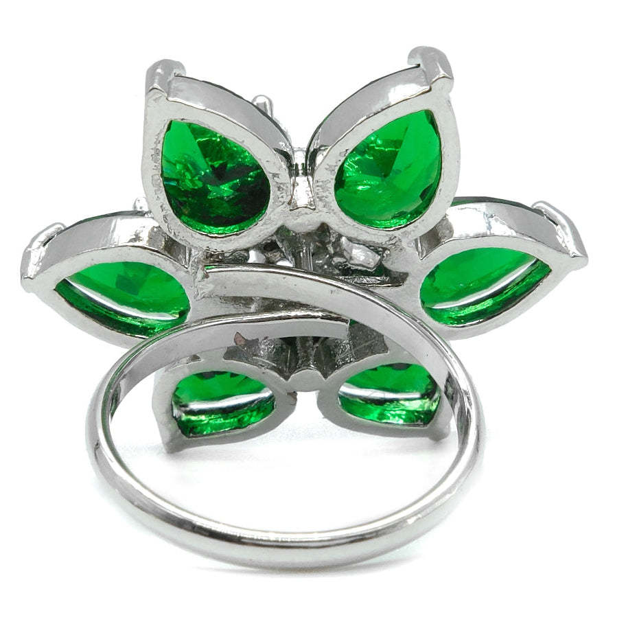 A silver butterfly ring featuring vibrant green teardrop-shaped gemstones, photographed on a clean white background.