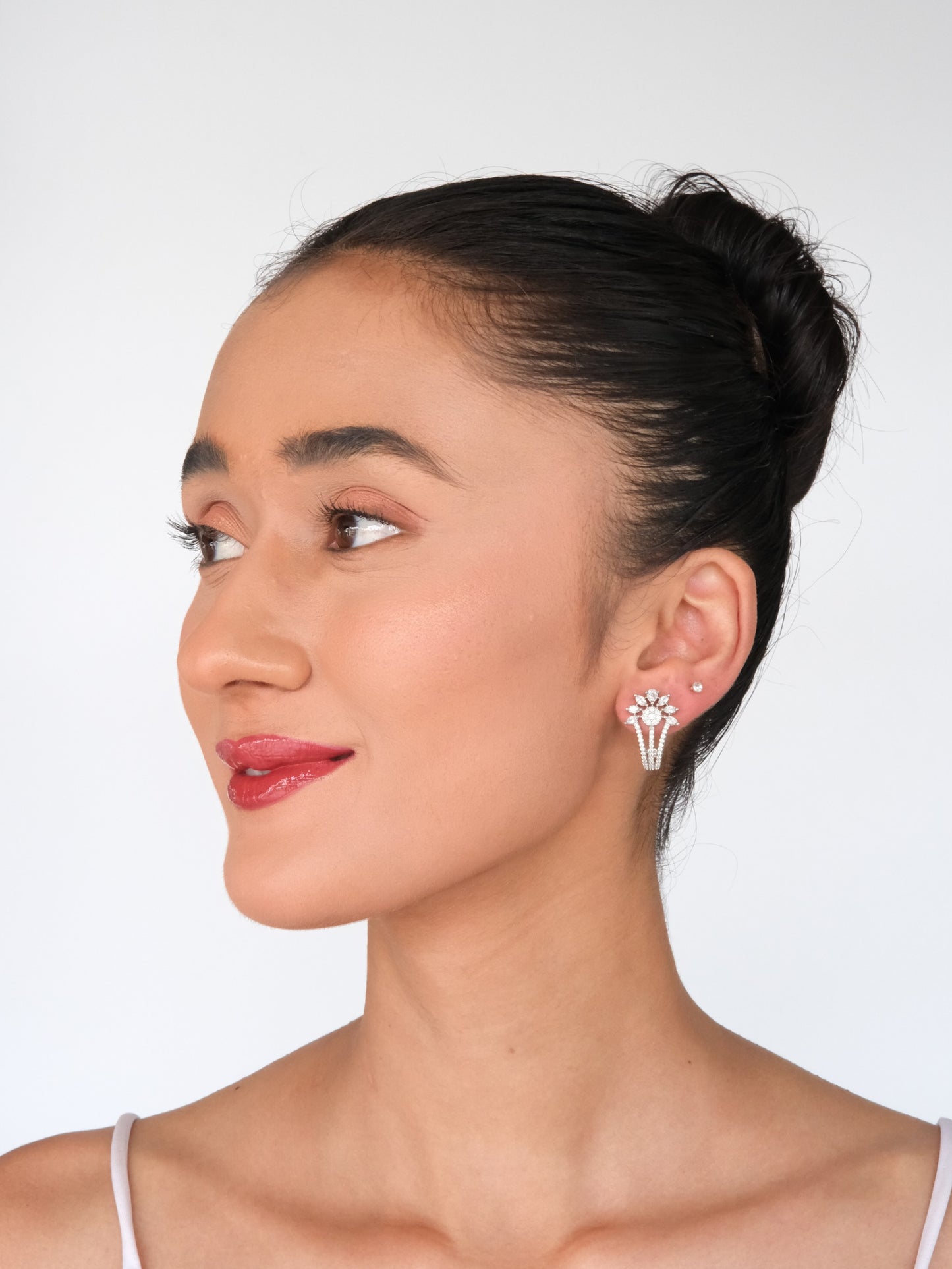 Elegant model in a side pose wearing Floral American Diamond Drop Earrings, showcasing sparkling floral design earrings for women.