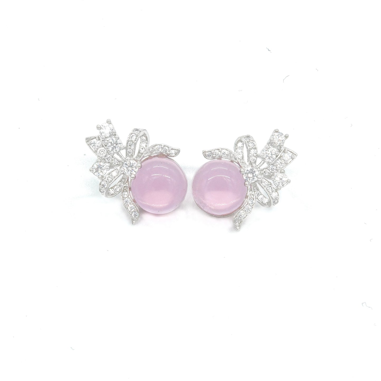 Front view of green stud earrings with bow design and white stones