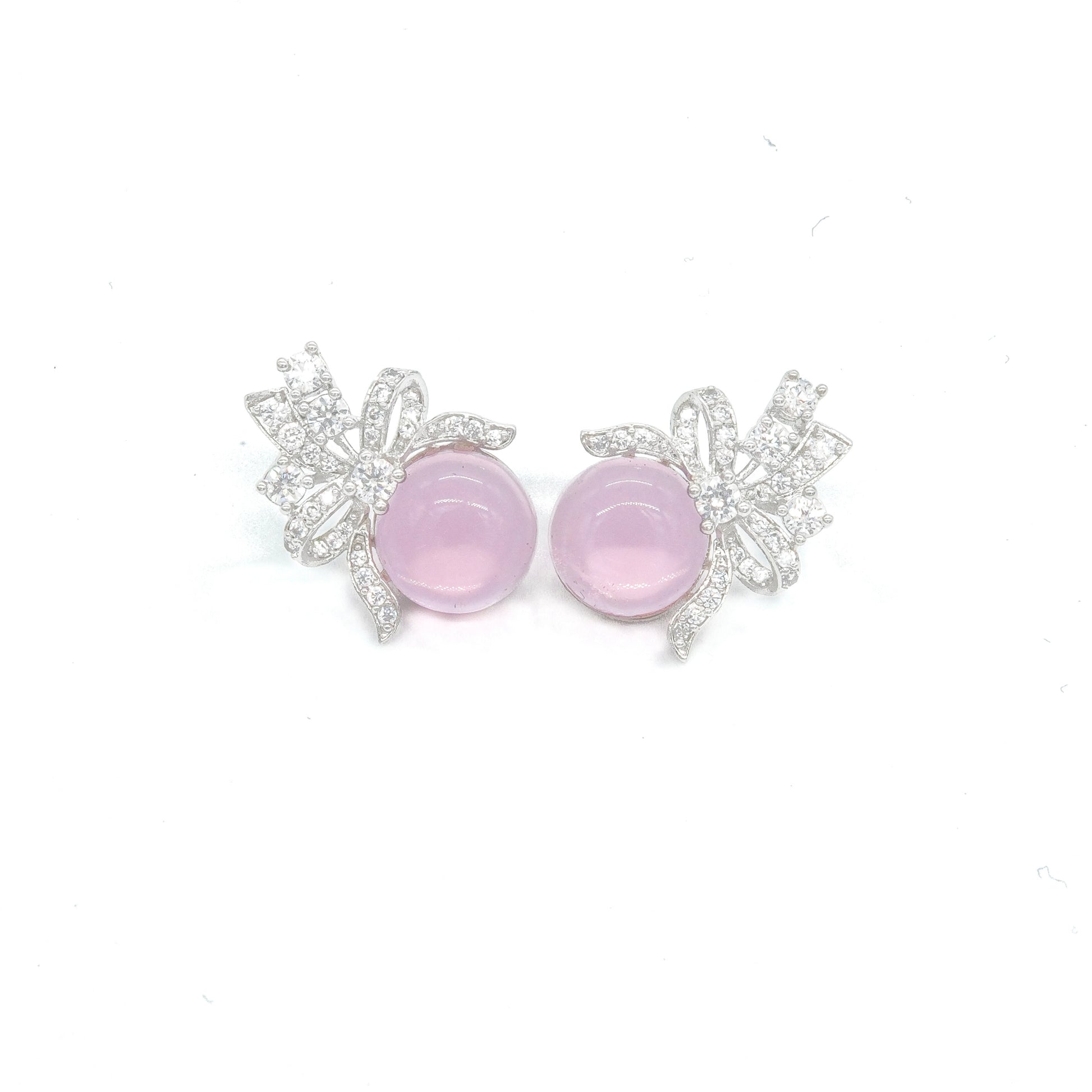 Front view of green stud earrings with bow design and white stones
