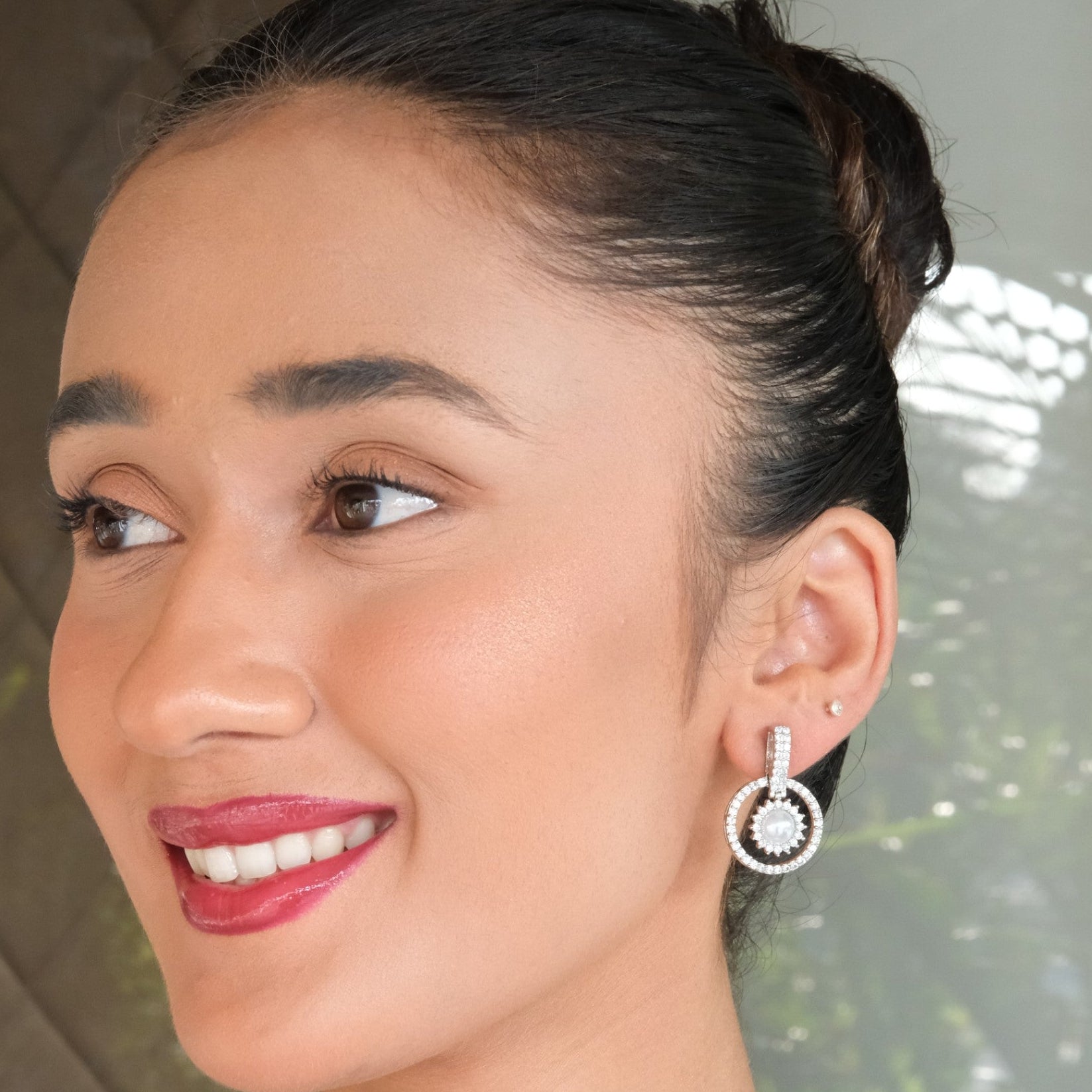 Woman wearing a diamond earring with a blurred background