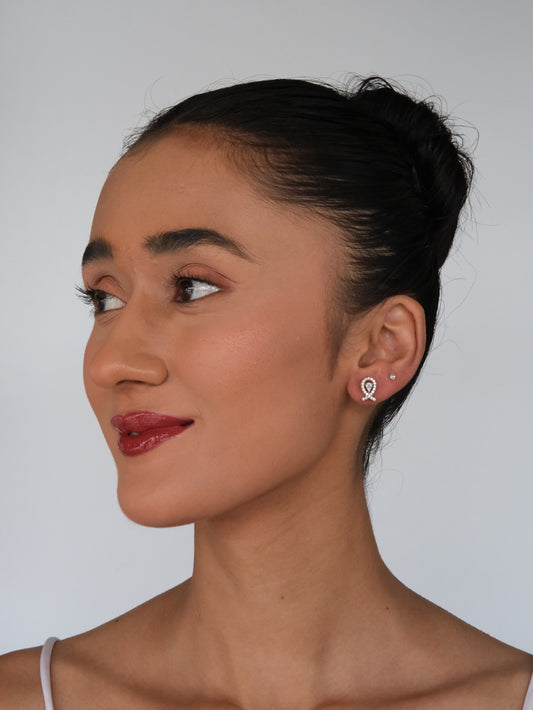 Model in a side pose wearing Infinity American Diamond Earrings, showcasing the elegant infinity design and sparkling American diamonds.