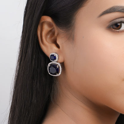 Model wearing blue stone drop earring – side close-up view”