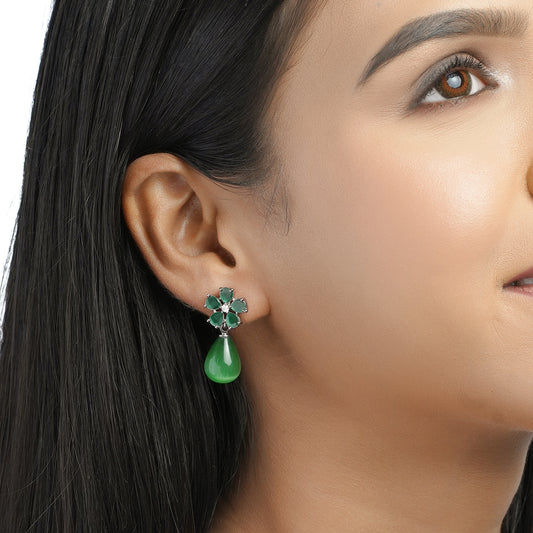 Model wearing green drop floral CZ earring close-up