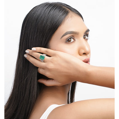 Model showing green statement ring worn near face