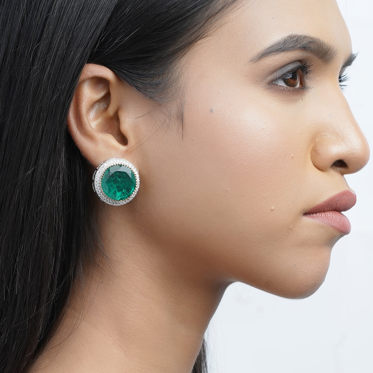 Model side view wearing large green statement earring