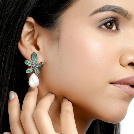 Model wearing green petal earrings with pearl drop close-up