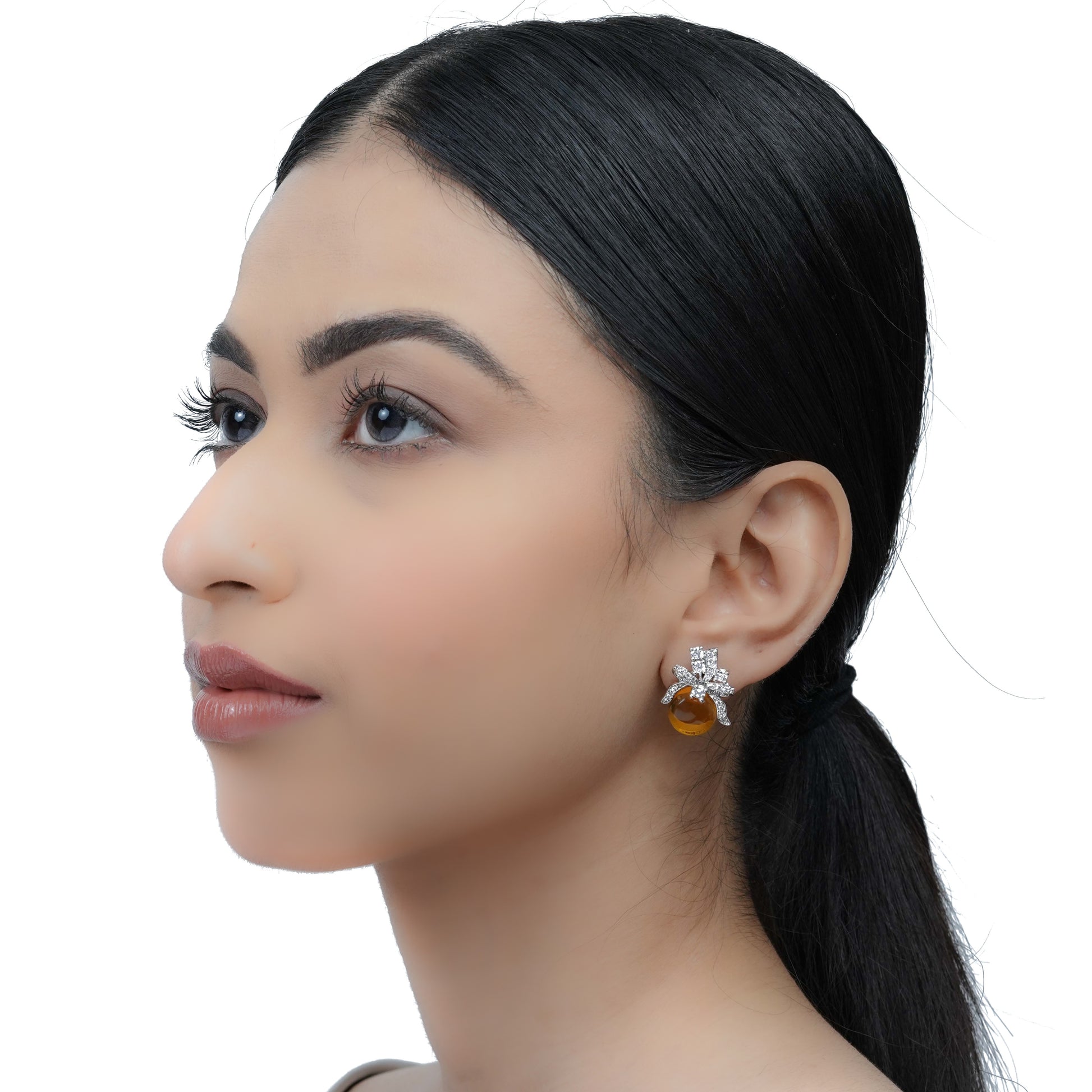 model wearing yellow bow stud earring with white CZ