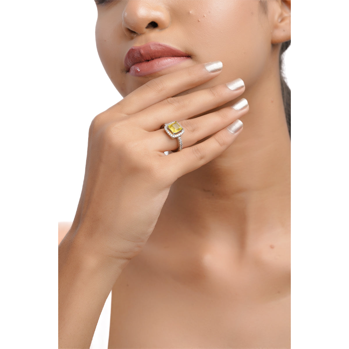 Model showing yellow CZ ring worn on hand in upper-body view