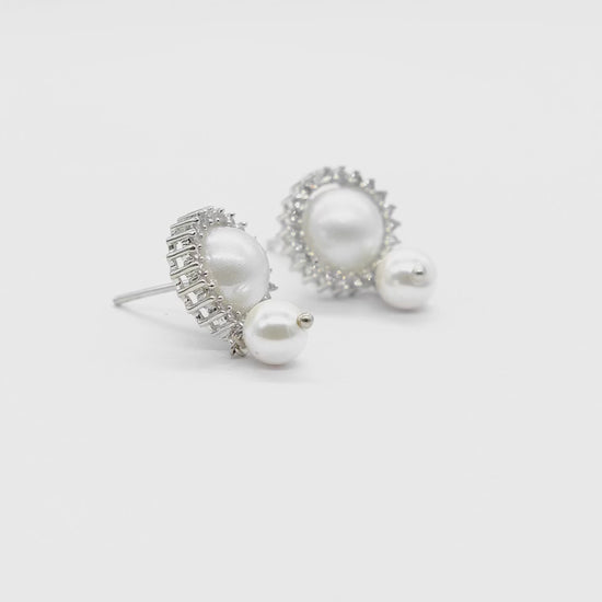 Product video of Pearl Halo American Diamond Stud Earrings on a white background, showcasing the elegant pearl halo design, sparkling American diamonds, and premium craftsmanship.