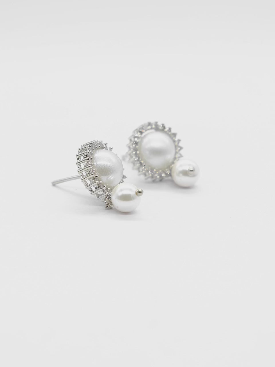 Product video of Pearl Halo American Diamond Stud Earrings on a white background, showcasing the elegant pearl halo design, sparkling American diamonds, and premium craftsmanship.