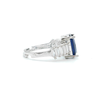 side view of blue stone ring with white background