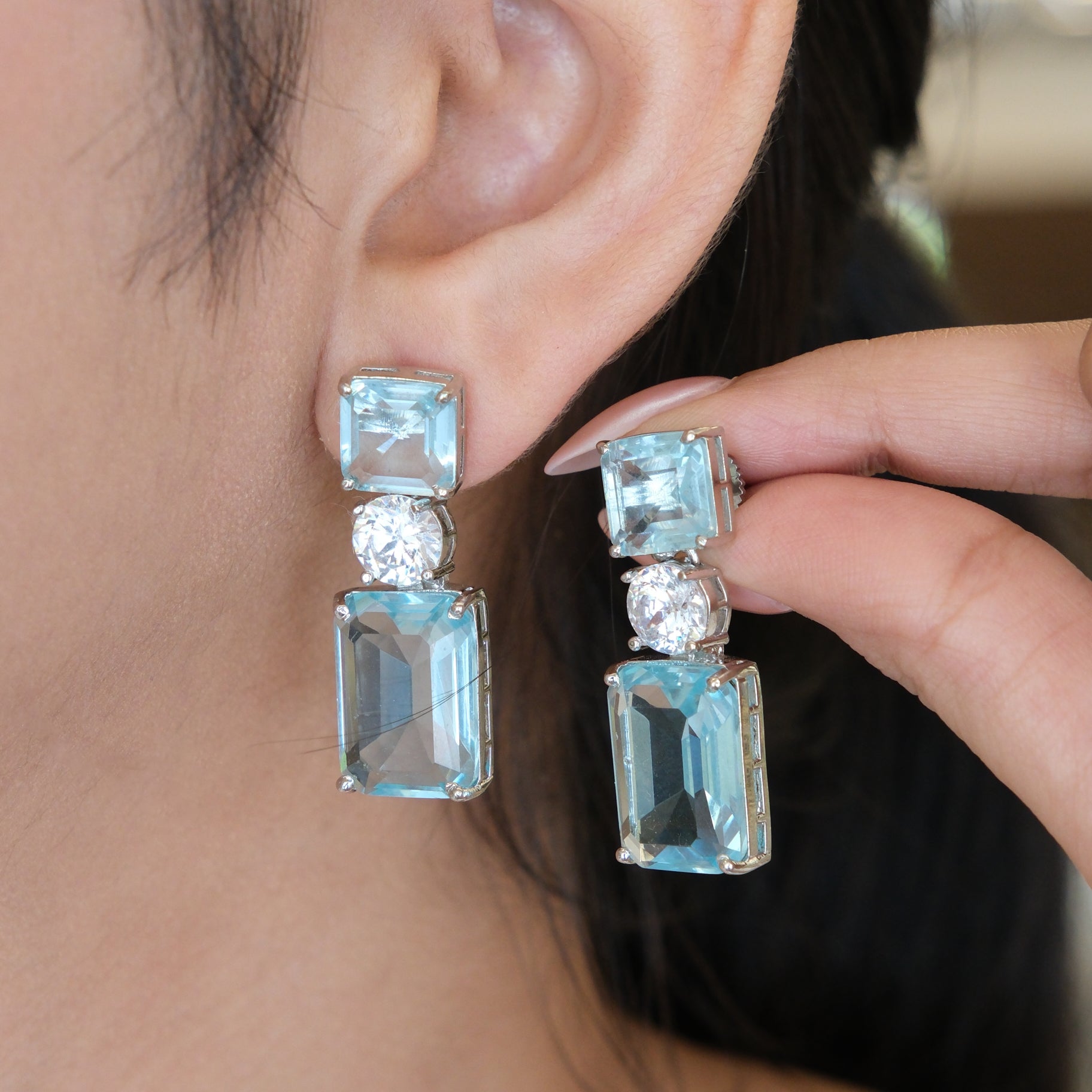 Close-up of a model wearing Sky Blue Geometric Drop Earrings, highlighting the elegant geometric design and sky blue stones.