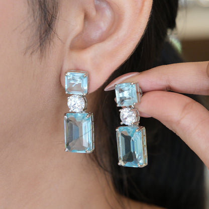 Close-up of a model wearing Sky Blue Geometric Drop Earrings, highlighting the elegant geometric design and sky blue stones.