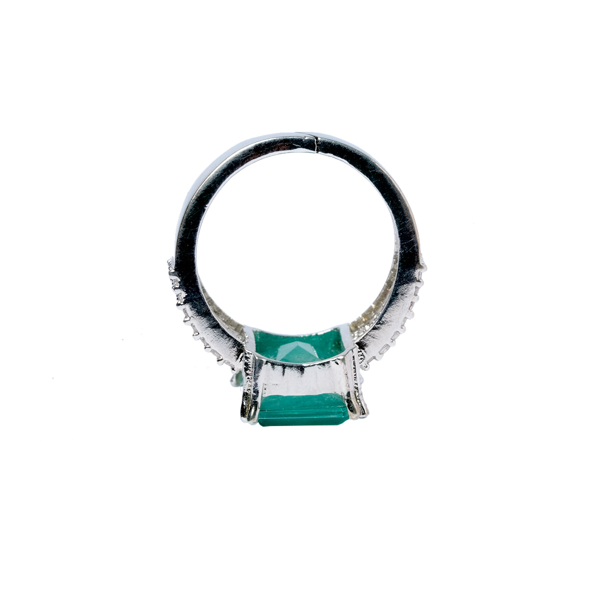 Top view of green stone ring showing round band and rectangular setting