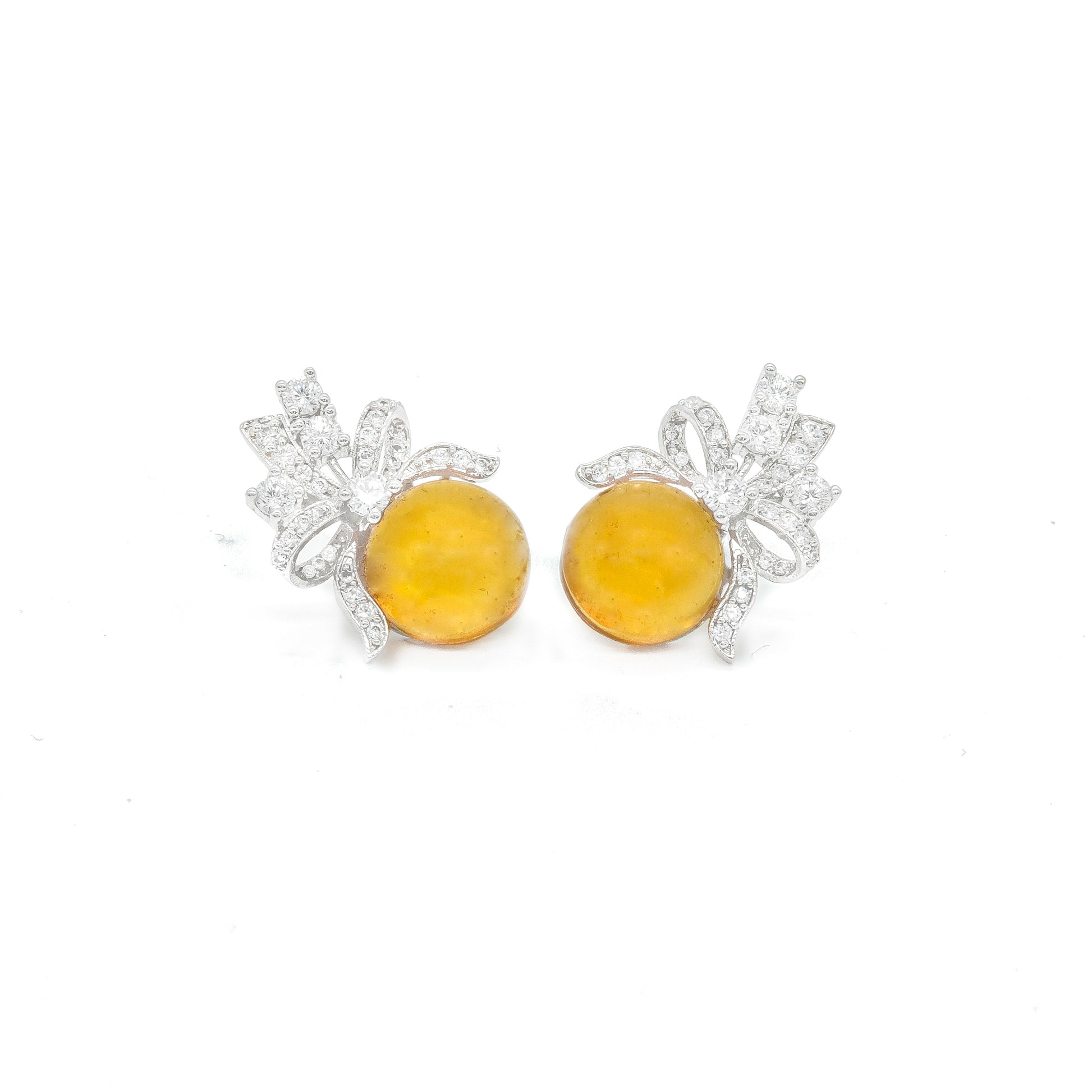 Front view of yellow stud earrings with bow design and white stones