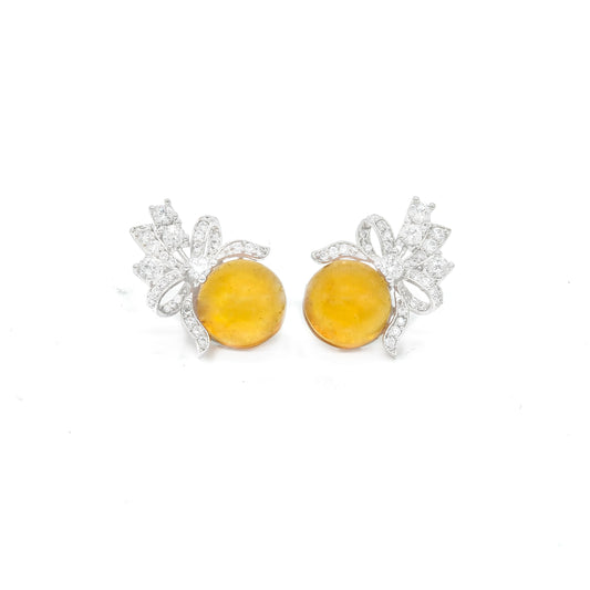 Front view of yellow stud earrings with bow design and white stones